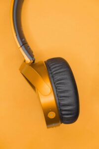 focus on on side of padded head phones that are gold in front of a gold background