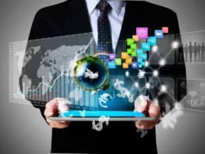 man holding tablet with holograms of Earth and other charts and graphs