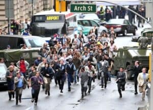 an image of people in the middle of the street seemingly running form a threat