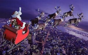 animated photo of santa riding in sleigh with raindeer