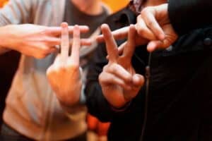 two people holding up fingers in a hashtag symbol